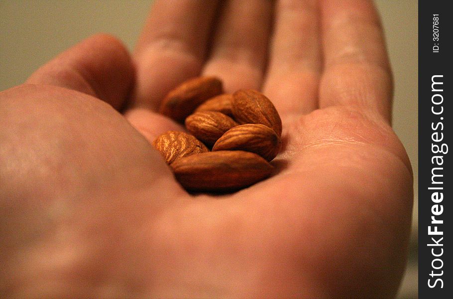 A handful of almond nuts on a palm