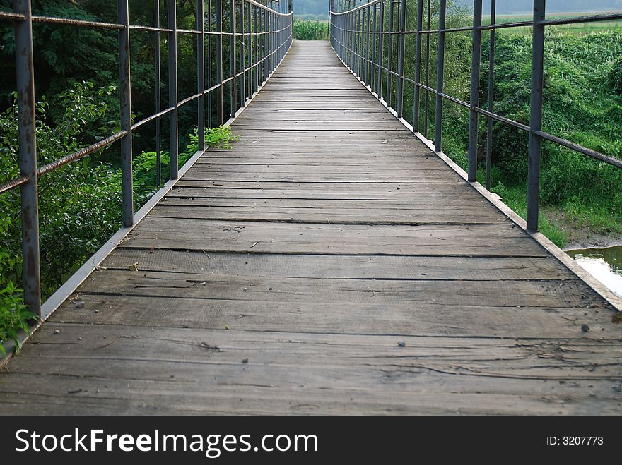 Old wooden bridge on the river