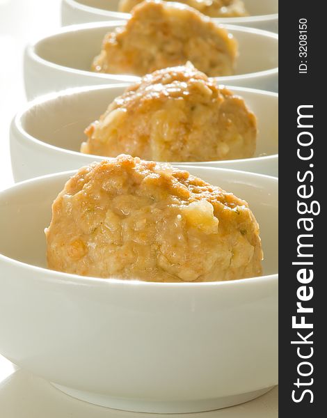 Beef and pork meat ball served on white bowls with focus on first ball