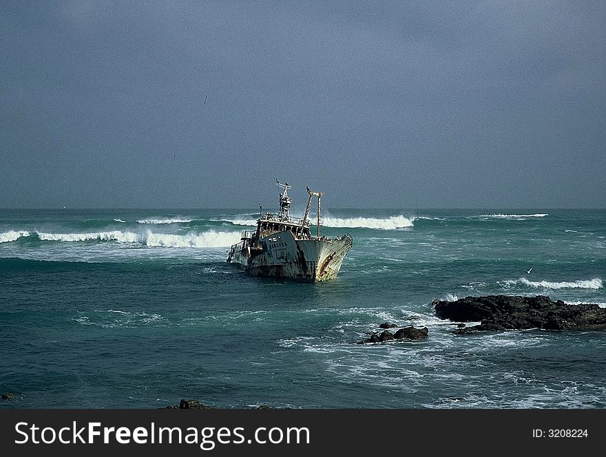 Old fishing trawler sitting on the rocks. Old fishing trawler sitting on the rocks