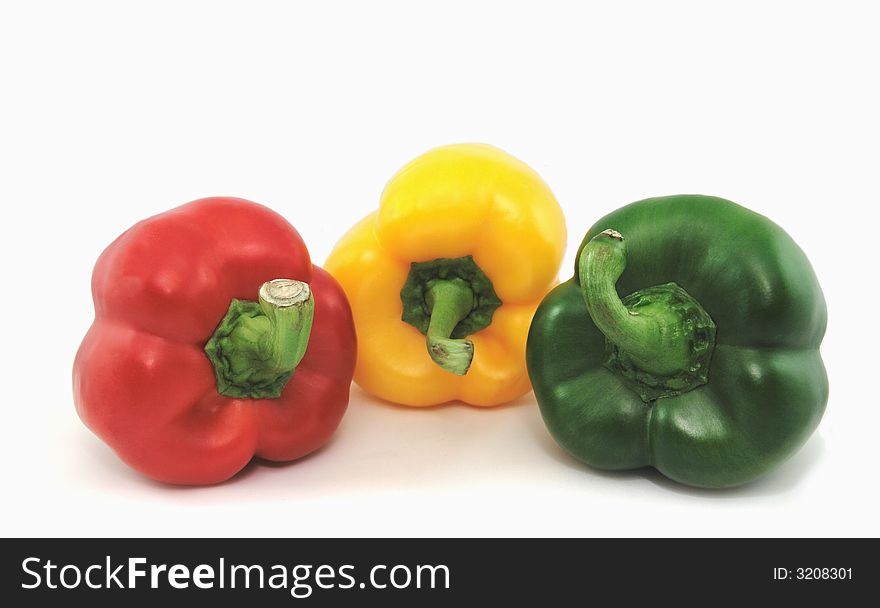 Red, Yellow and green peppers isolated against a white background