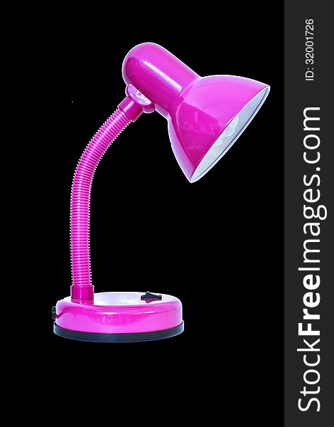 Pink table lamp isolated on a black background