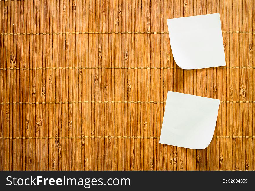 Yellow paper note and bamboo plate background