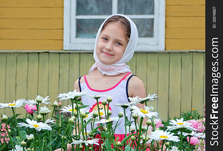 A child in a flower garden. A child in a flower garden