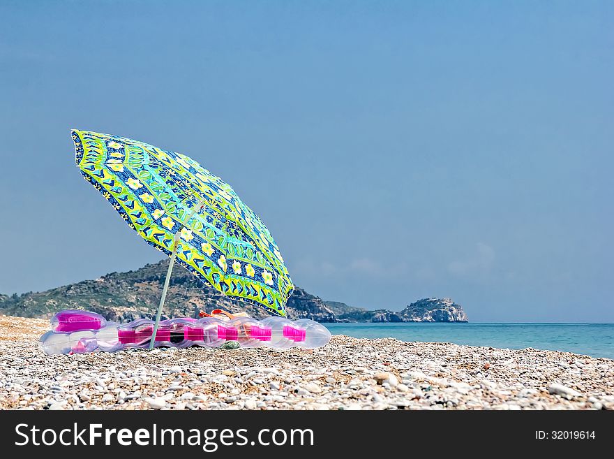 Sunshade and air bed on the beach. Sunshade and air bed on the beach