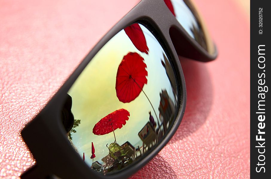 Rainbow sun glasses on a red background