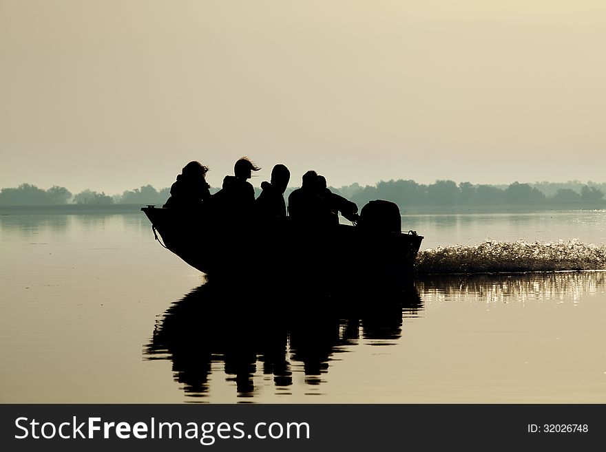 Silhouetted Boat Going Down The River