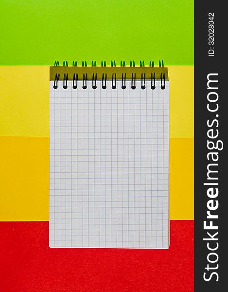 open note book with space for writing lies on a colorful background