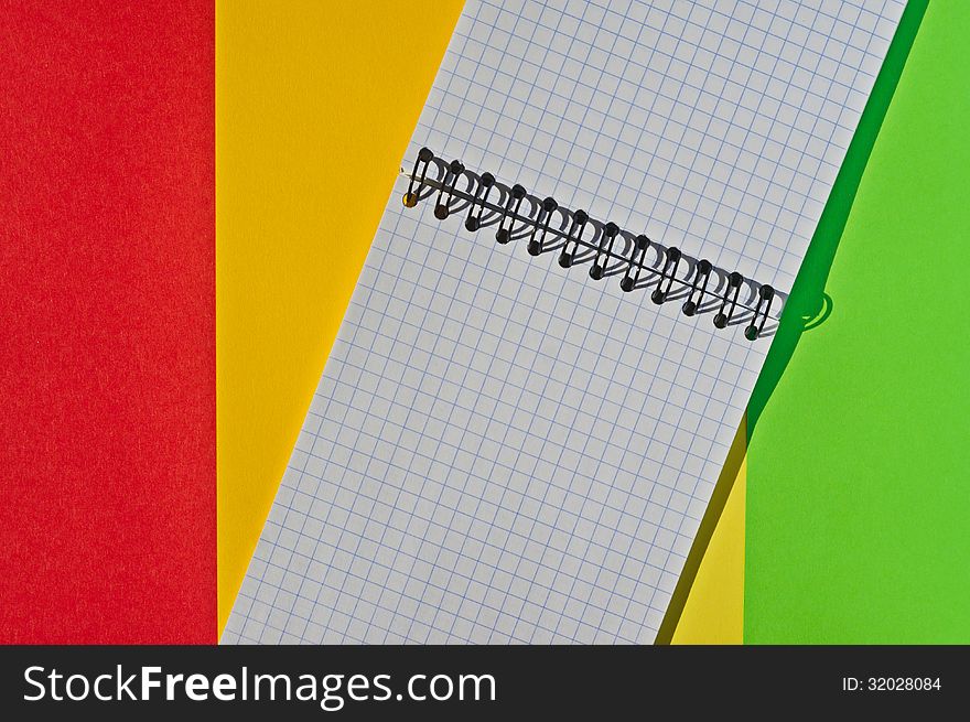Open note book with space for writing lies on a colorful background