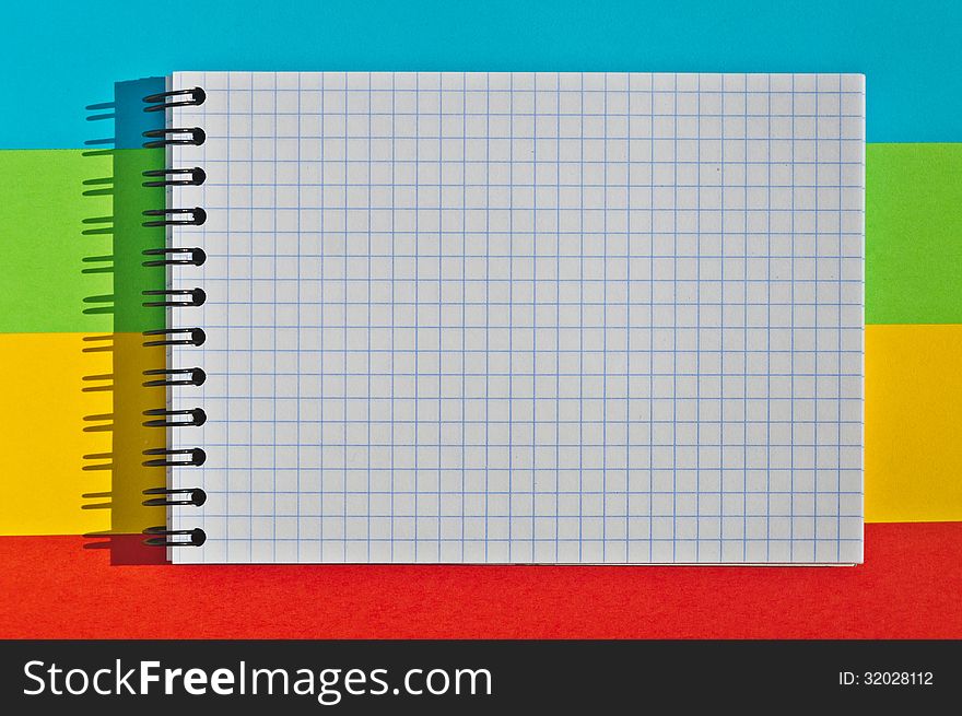 Open note book with space for writing lies on a colorful background