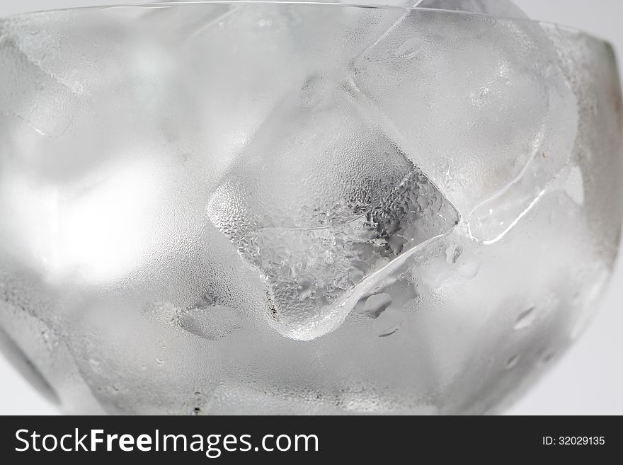 Abstract backgrounds with ice cubes over wet glass.