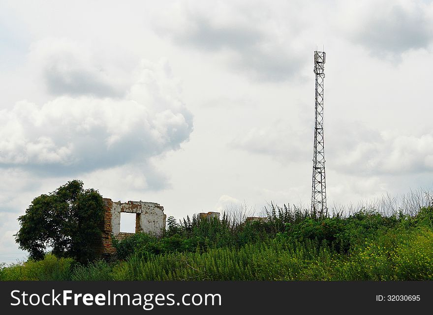 Telecommunication antenna tower among the ruins