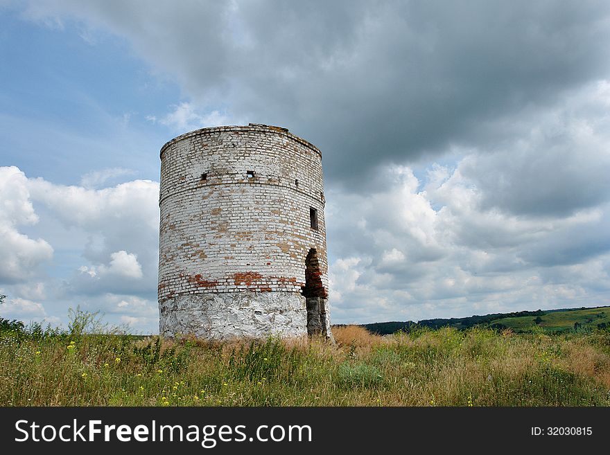 Ruins of the the old brick water tower with cloudy sky