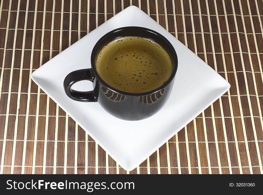 Cup Of Coffee On A White Plate