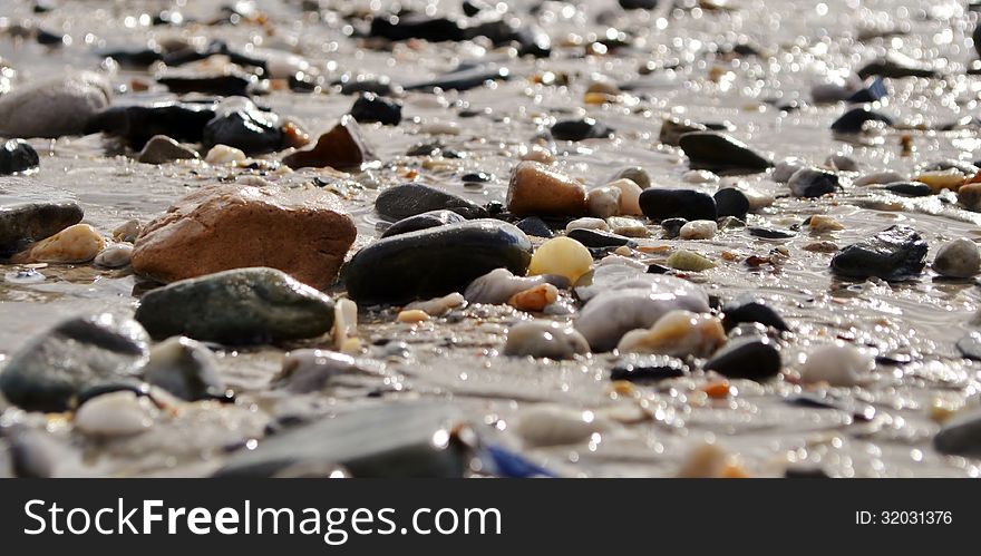 Close up of beach pebbles after rain