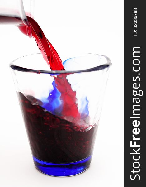 Pour red wine into deorated glass. Pour red wine into deorated glass