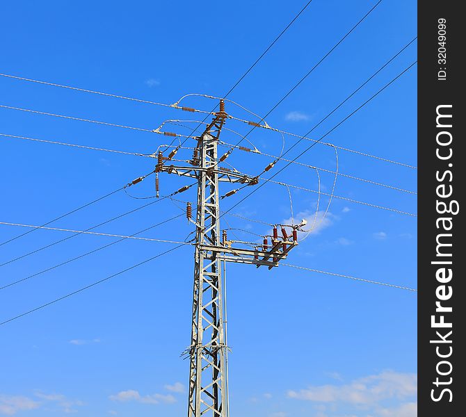 High voltage electricity pillars on the blue sky background