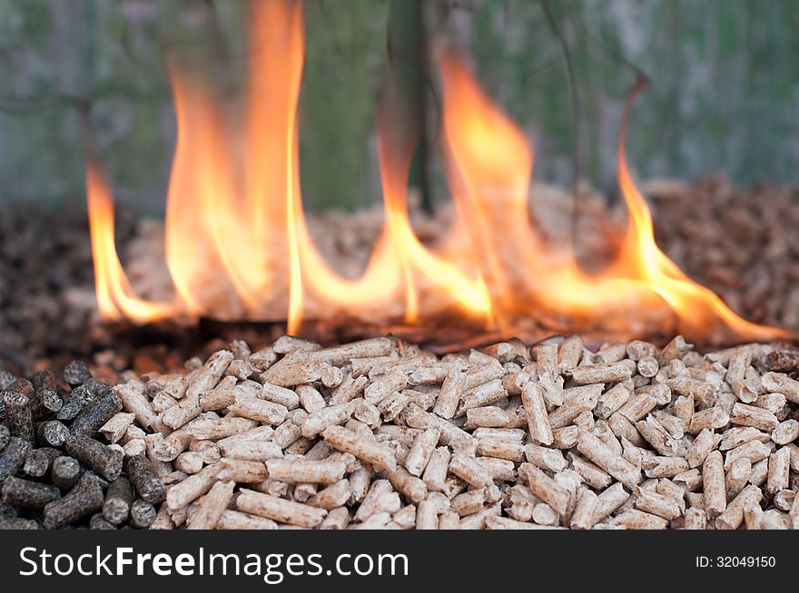 Pellets in flames - selective focus on the heap. Pellets in flames - selective focus on the heap