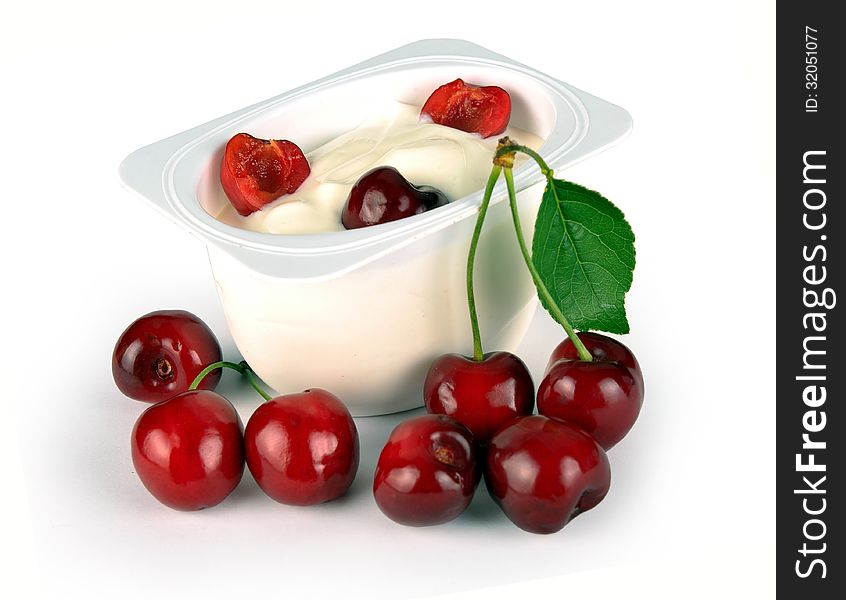 Yoghurt with cherry on a white background