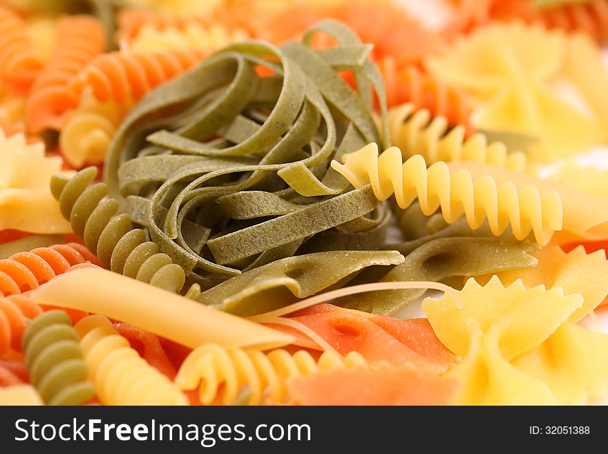 Different pasta in three colors. Close-up. Background.