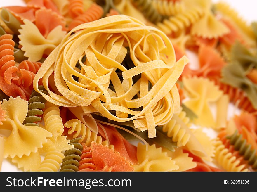 Different pasta in three colors. Close-up. Background.