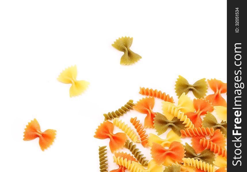 Different pasta in three colors. White background.