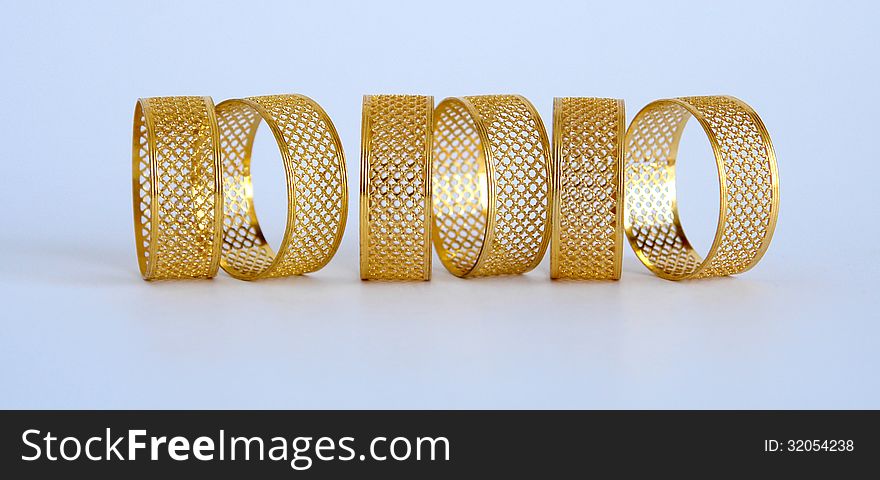 Golden napkin holders in the form of openwork rings