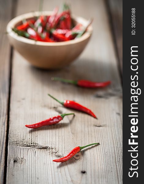 Red Hot Chili Peppers in bowl over wooden background. Red Hot Chili Peppers in bowl over wooden background