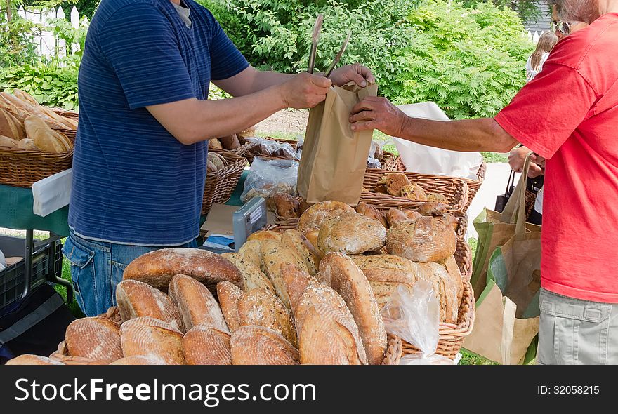 Sale of organic loaves at outdoor farmers market. Sale of organic loaves at outdoor farmers market