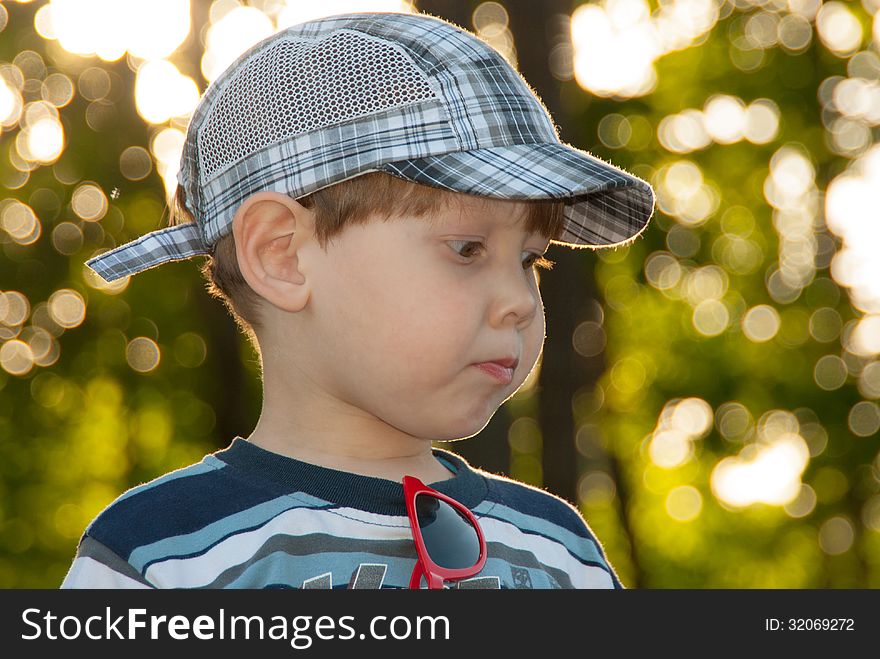 The little boy in a cap, looks aside