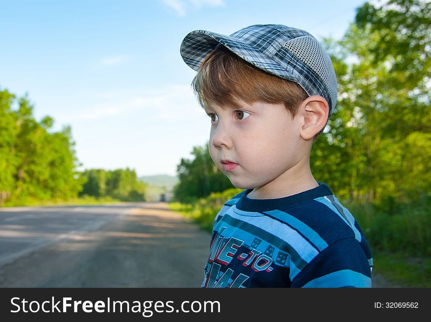 The little boy in a cap looks an amazed look