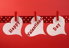 Happy Valentines Day Message Greeting Written Across White Heart Tags Hanging From Red Pegs On A Line Stock Photo