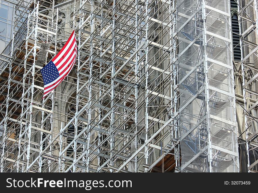 The flag is a great contrast to the grey scaffolding. The flag is a great contrast to the grey scaffolding