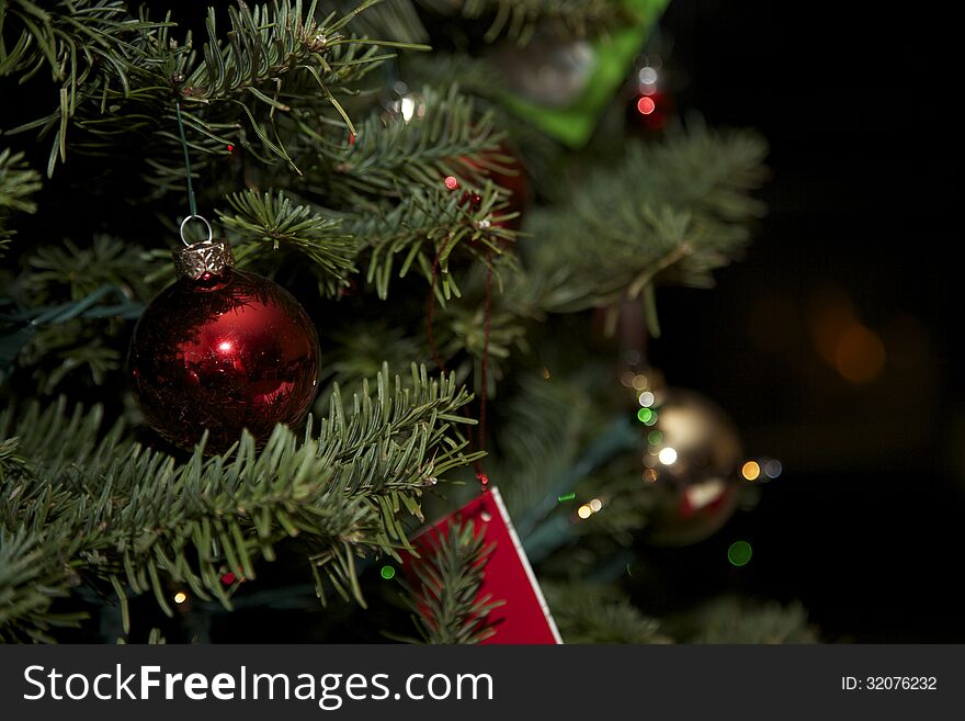An evergreen Christmas Tree with a red ornaments of several colors. An evergreen Christmas Tree with a red ornaments of several colors.