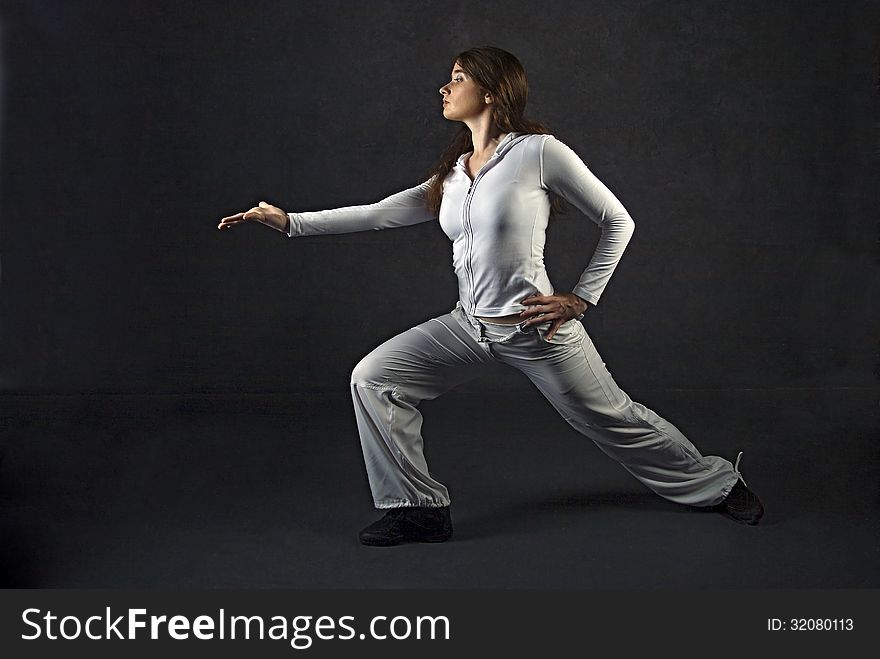 Young woman posing against gray concrete wall. Young woman posing against gray concrete wall