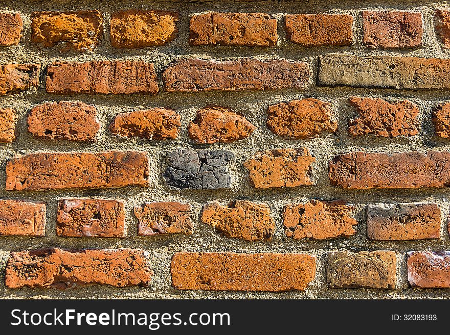Closeup of the brick wall enlightened by the sun.