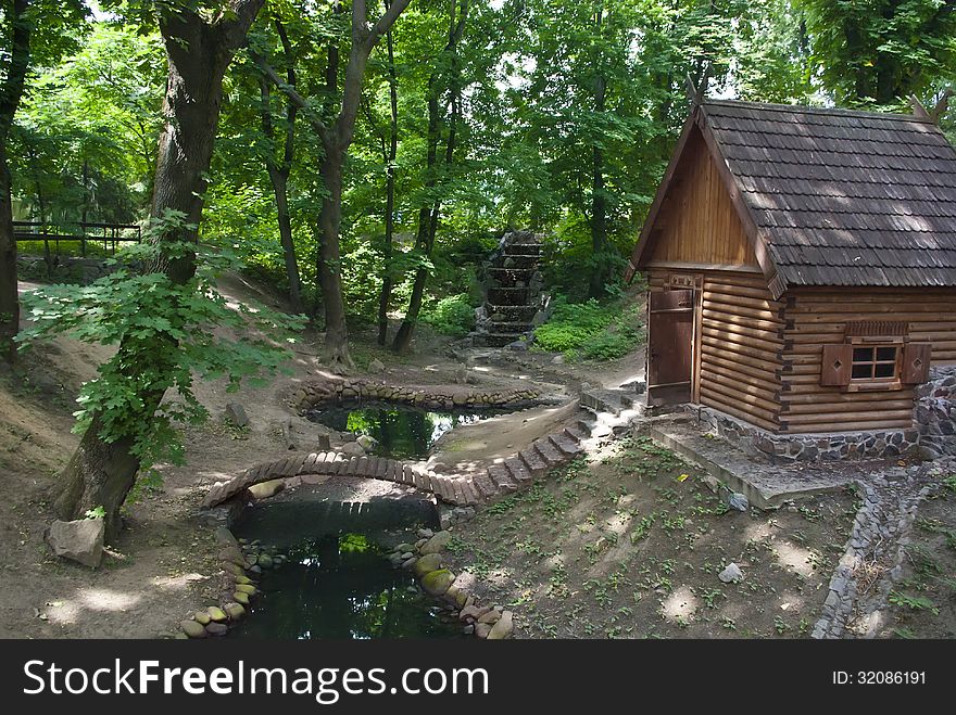 Green park with small pond and wood house in Kiev, Ukraine