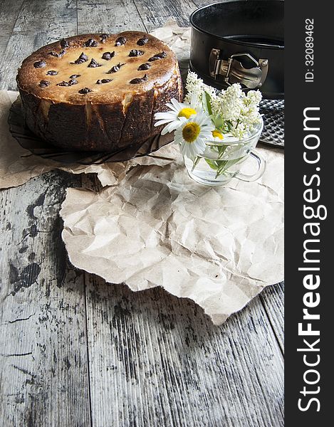 Cheesecake with a bouquet of daisies. Vertical shot.
