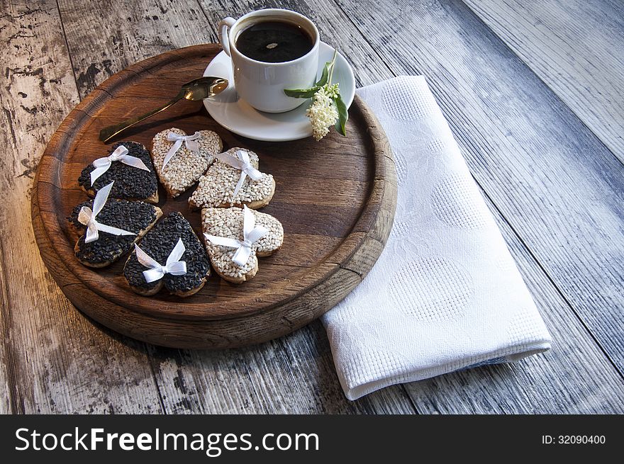 Cookies for the wedding with a cup of coffee served with a golden spoon. From the series Wedding Cookies. Cookies for the wedding with a cup of coffee served with a golden spoon. From the series Wedding Cookies