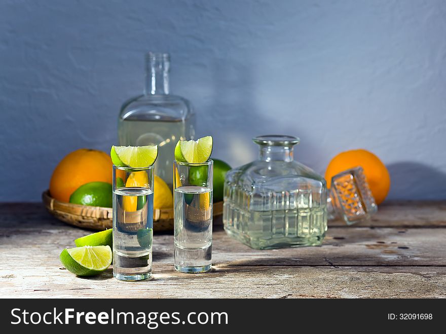 Tequila and citrus fruits on a old table