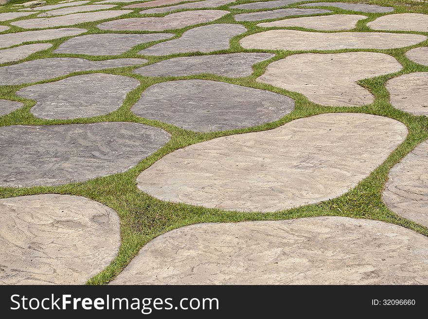 The pavement made of free form rock and grass. The pavement made of free form rock and grass