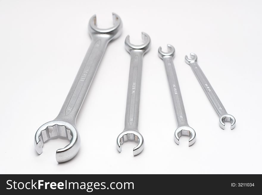 Four wrenches isolated on semi-white background