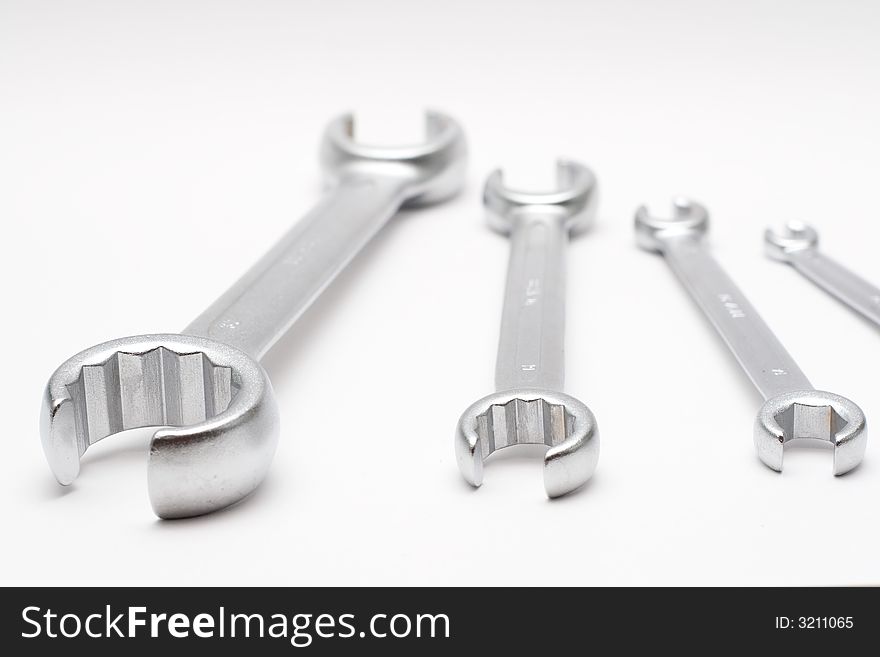 Four wrenches isolated on semi-white background