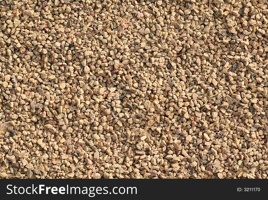 Close up at Small stones with pieces of grass good as a background. Close up at Small stones with pieces of grass good as a background