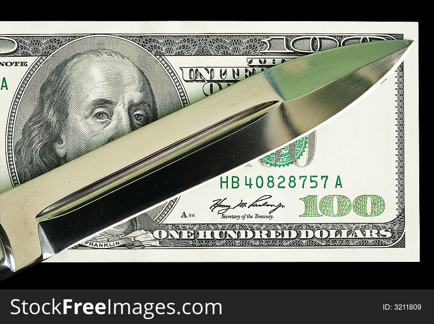 The criminal knife lays on 100 dollar banknote. The criminal knife lays on 100 dollar banknote