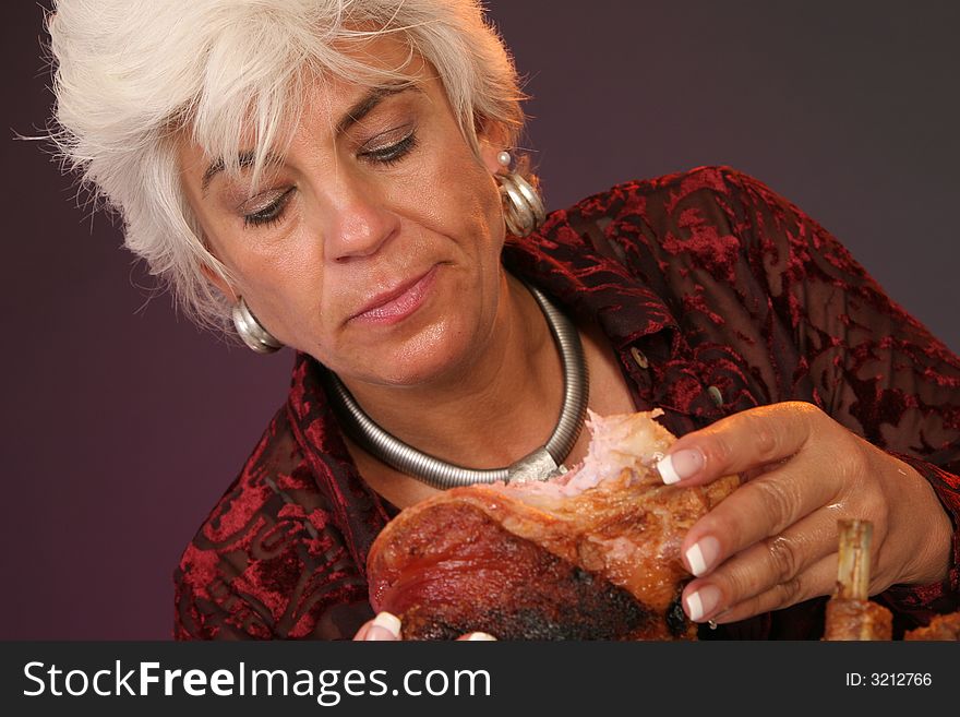 Woman looking on a big part of meat. Woman looking on a big part of meat