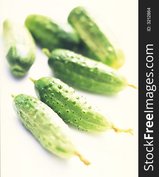 Green cucumbers on a white background