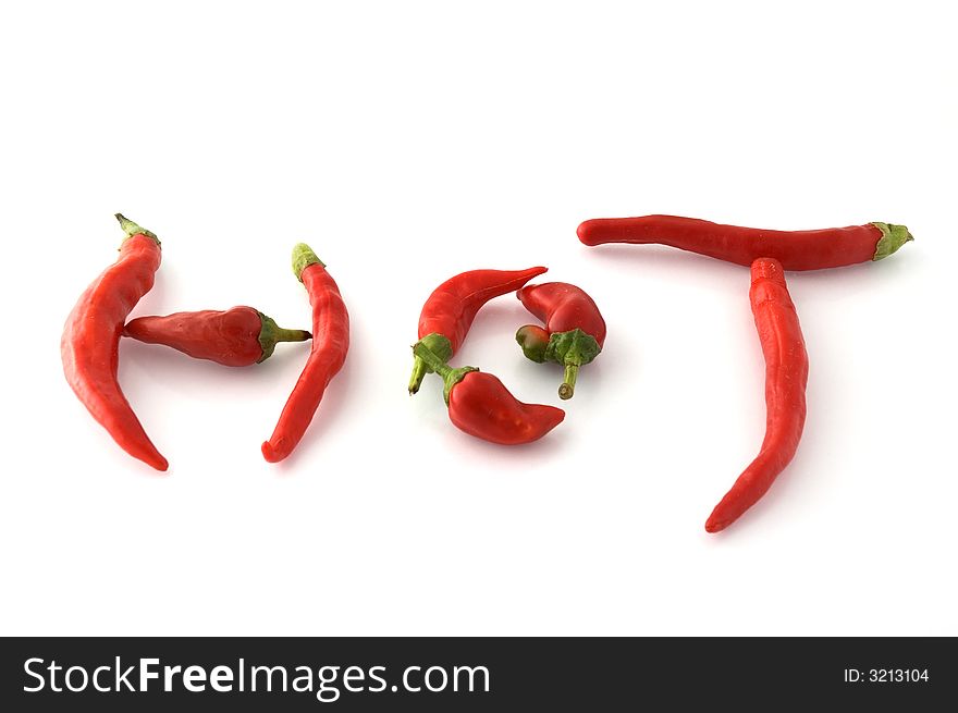 Chili peppers forming the word hot isolated on white. Chili peppers forming the word hot isolated on white