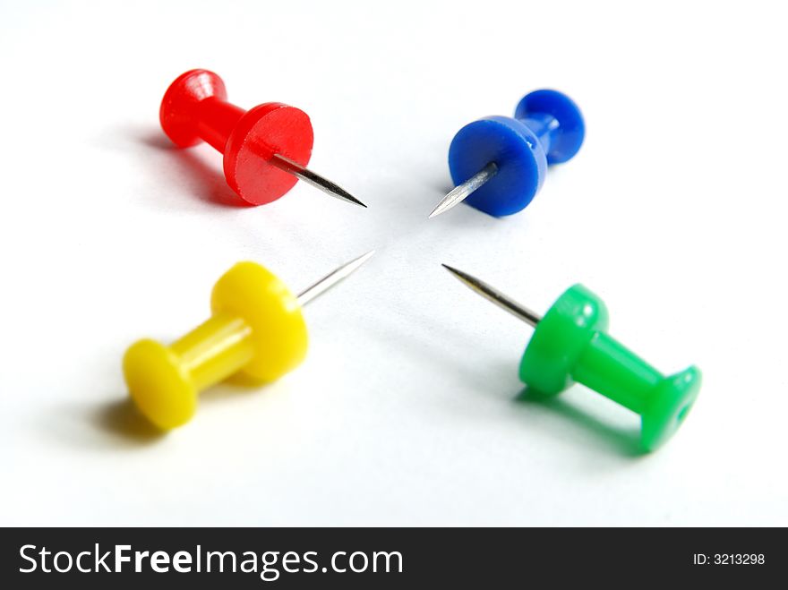 Four attractive colour pins pointing each other