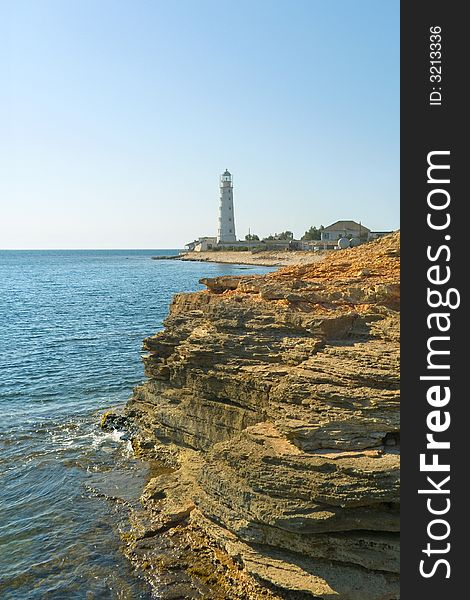 Lighthouse, sea and rock, blue sky